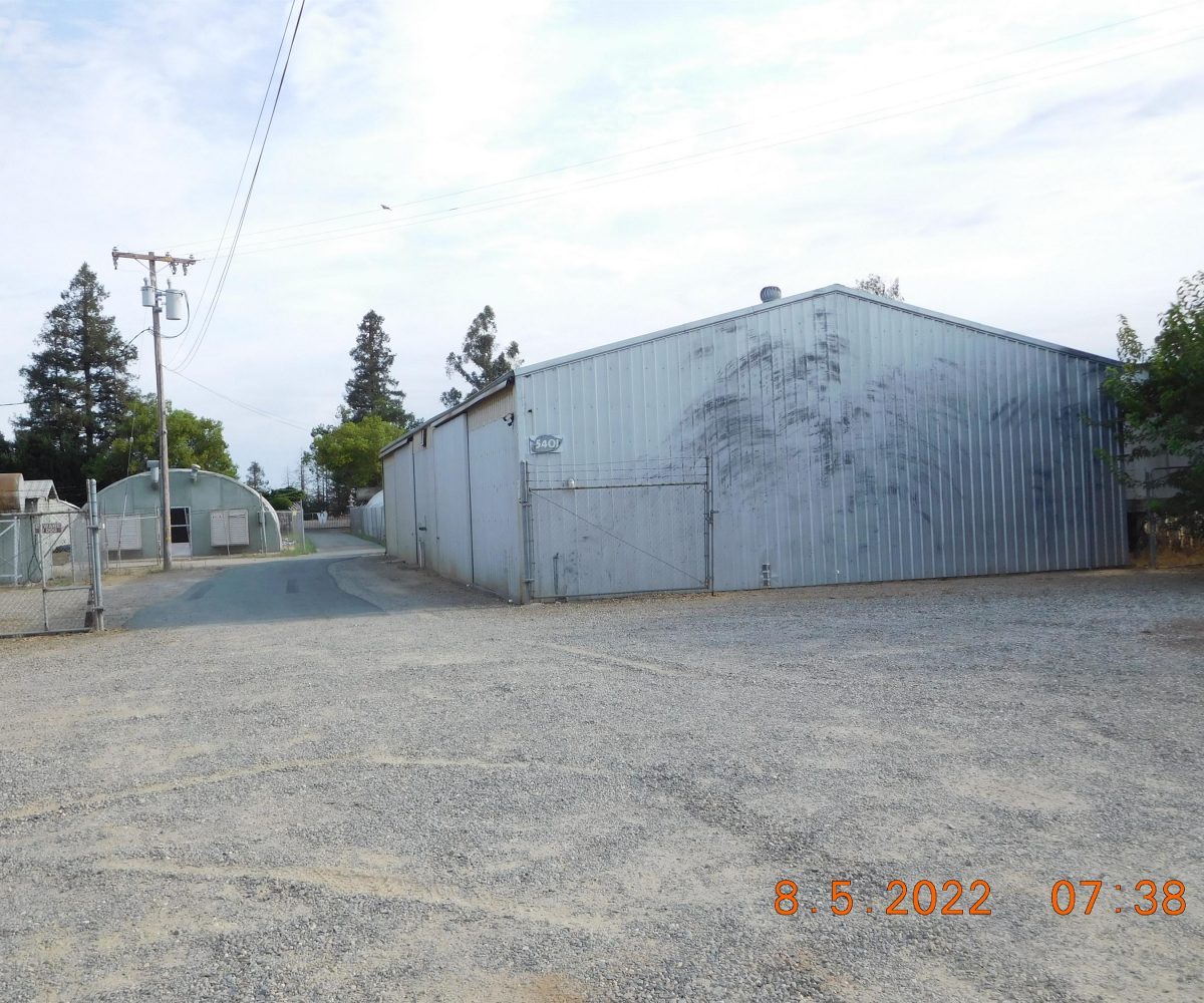 Non-residential wooden warehouse in countryside under clear blue sky
