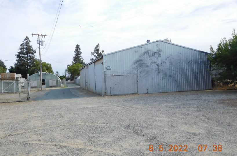 Non-residential wooden warehouse in countryside under clear blue sky