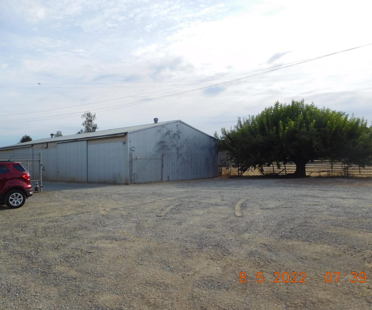 Non-residential wooden warehouse in countryside under clear blue sky
