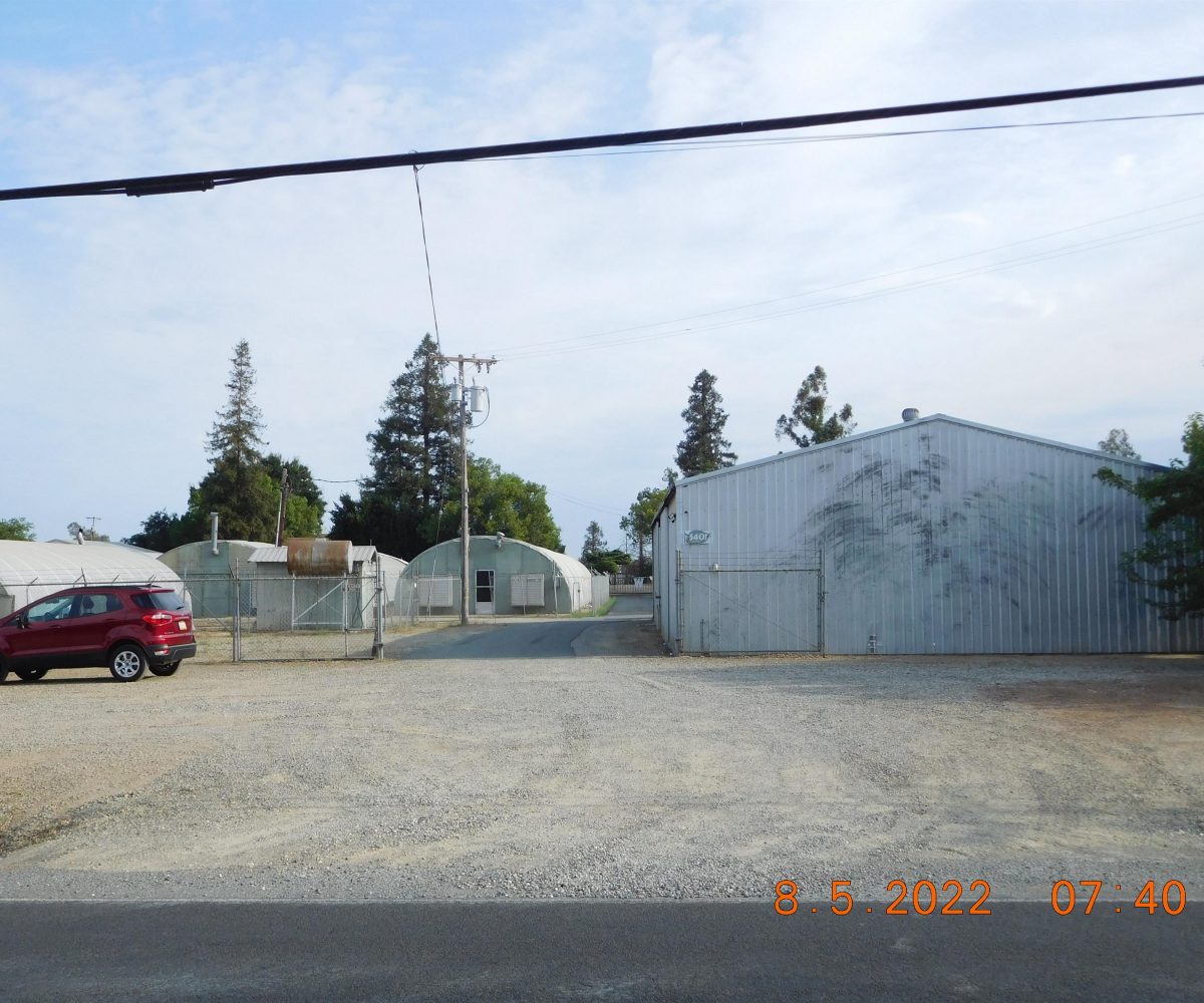 Non-residential wooden warehouse in countryside under clear blue sky