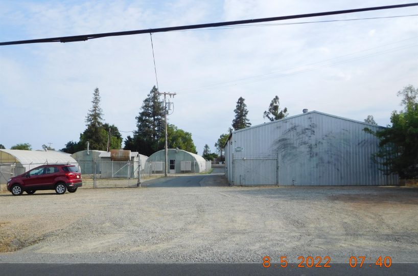 Non-residential wooden warehouse in countryside under clear blue sky