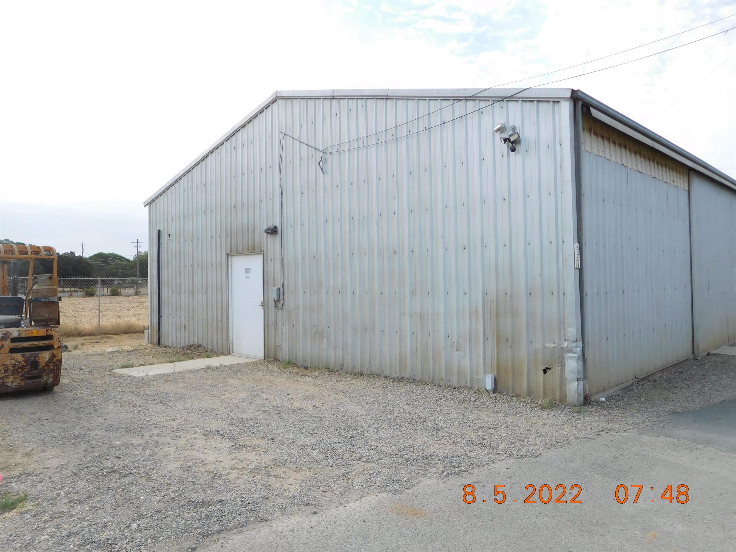 Non-residential wooden warehouse in countryside under clear blue sky